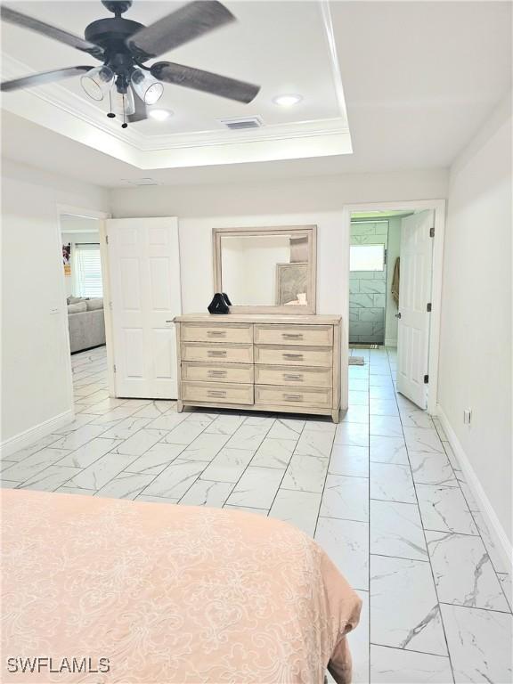 303 E 7th St, Lehigh Acres, FL 33972 - bedroom with baseboards, crown molding, light marble finish floors, a tray ceiling, and recessed lighting
