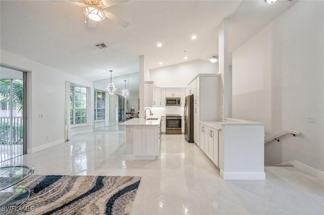 74 Silver Oaks Cir Unit 9-202, Naples, FL 34119 - kitchen featuring appliances with stainless steel finishes, a sink, vaulted ceiling, a chandelier, and light countertops