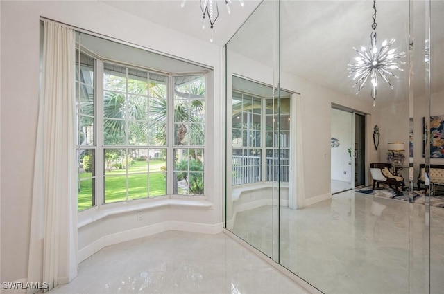 74 Silver Oaks Cir Unit 9-202, Naples, FL 34119 - unfurnished dining area featuring plenty of natural light, a chandelier, and baseboards