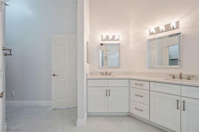 74 Silver Oaks Cir Unit 9-202, Naples, FL 34119 - bathroom featuring double vanity, baseboards, and tile patterned floors