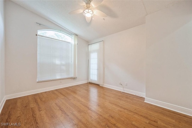 74 Silver Oaks Cir Unit 9-202, Naples, FL 34119 - spare room featuring vaulted ceiling, ceiling fan, light wood finished floors, baseboards, and a textured ceiling