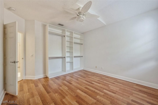 74 Silver Oaks Cir Unit 9-202, Naples, FL 34119 - unfurnished bedroom with light wood-type flooring, baseboards, a textured ceiling, a closet, and ceiling fan