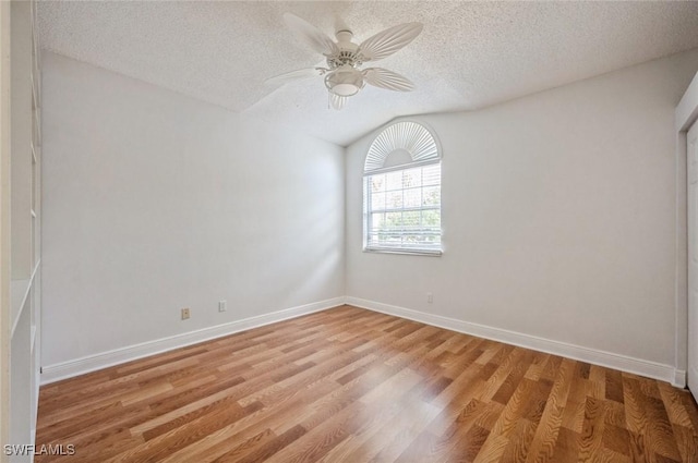74 Silver Oaks Cir Unit 9-202, Naples, FL 34119 - spare room with a textured ceiling, light wood-type flooring, baseboards, ceiling fan, and lofted ceiling
