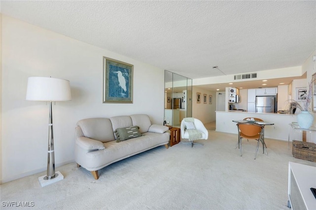 180 Seaview Ct Unit 607, Marco Island, FL 34145 - living area featuring light carpet and a textured ceiling