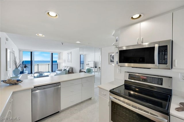180 Seaview Ct Unit 607, Marco Island, FL 34145 - kitchen with stainless steel appliances, light countertops, white cabinetry, and recessed lighting