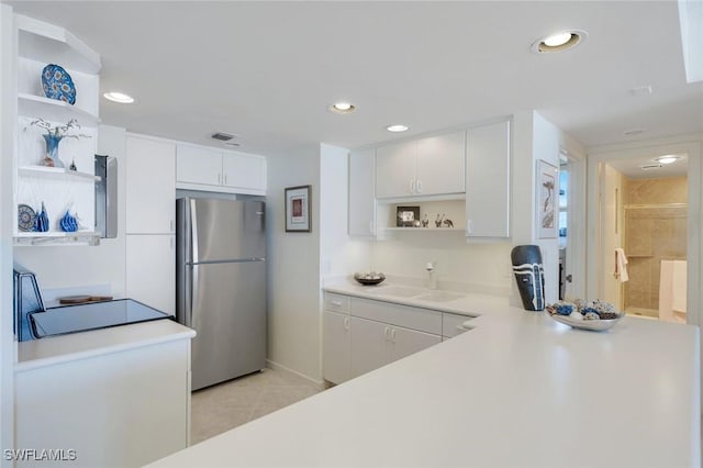 180 Seaview Ct Unit 607, Marco Island, FL 34145 - kitchen with open shelves, freestanding refrigerator, white cabinetry, light countertops, and recessed lighting