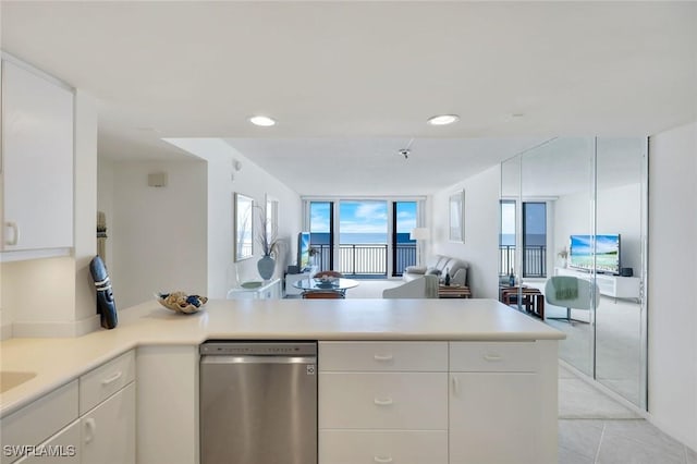 180 Seaview Ct Unit 607, Marco Island, FL 34145 - kitchen featuring dishwasher, a peninsula, open floor plan, light countertops, and white cabinets