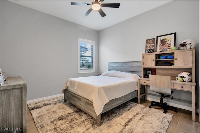 15889 Cranes Marsh Ct, Punta Gorda, FL 33982 - bedroom with an office area, baseboards, wood finished floors, and a ceiling fan