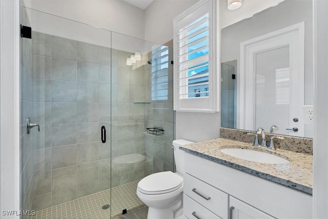15889 Cranes Marsh Ct, Punta Gorda, FL 33982 - full bathroom featuring vanity, a stall shower, toilet, and tile patterned floors
