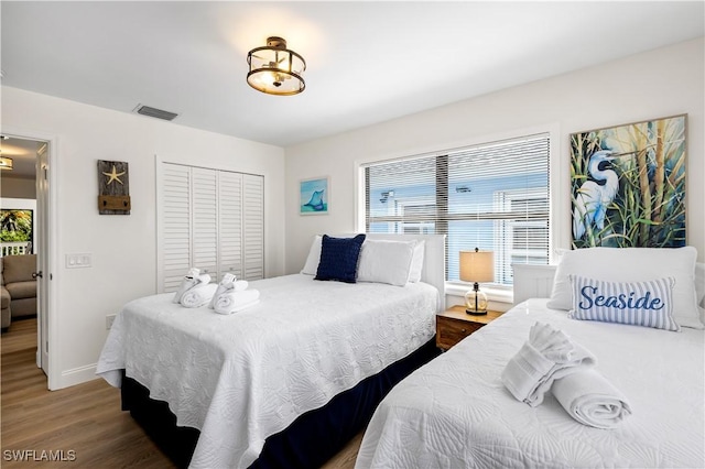 250 Ohio Ave, Fort Myers Beach, FL 33931 - bedroom with wood finished floors, multiple windows, a closet, and baseboards