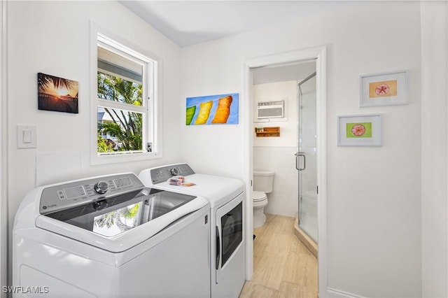 250 Ohio Ave, Fort Myers Beach, FL 33931 - laundry area featuring separate washer and dryer, tile walls, and light wood finished floors