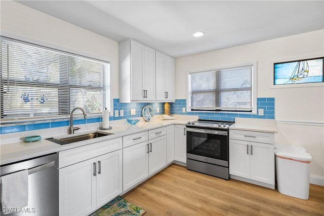 250 Ohio Ave, Fort Myers Beach, FL 33931 - kitchen with stainless steel appliances, a sink, decorative backsplash, plenty of natural light, and recessed lighting