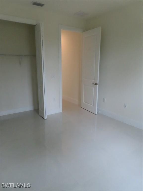 4132 64th Ave NE, Naples, FL 34120 - unfurnished bedroom with concrete flooring and a closet