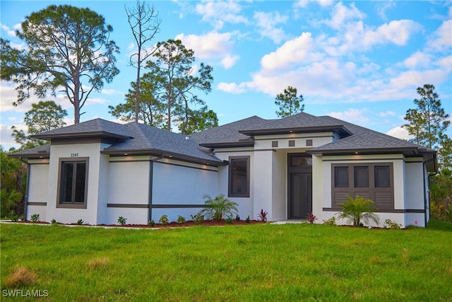 4132 64th Ave NE, Naples, FL 34120 - prairie-style home with stucco siding and a front lawn