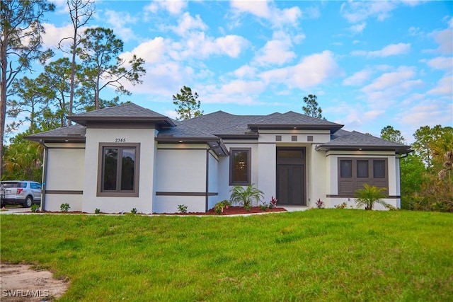 4132 64th Ave NE, Naples, FL 34120 - prairie-style house with a front lawn, stucco siding, and roof with shingles