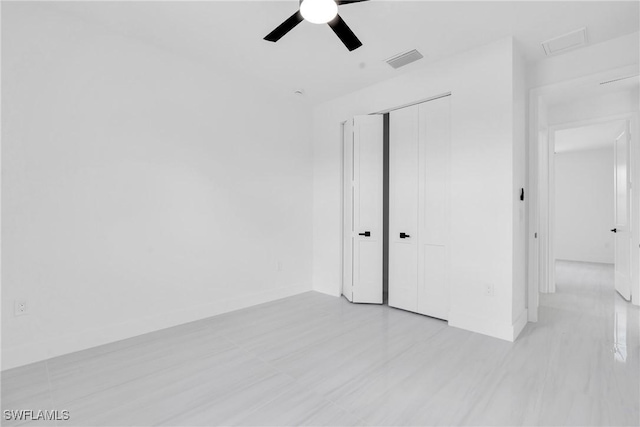 331 Naples Ave S, Lehigh Acres, FL 33974 - unfurnished bedroom with a closet, attic access, and a ceiling fan