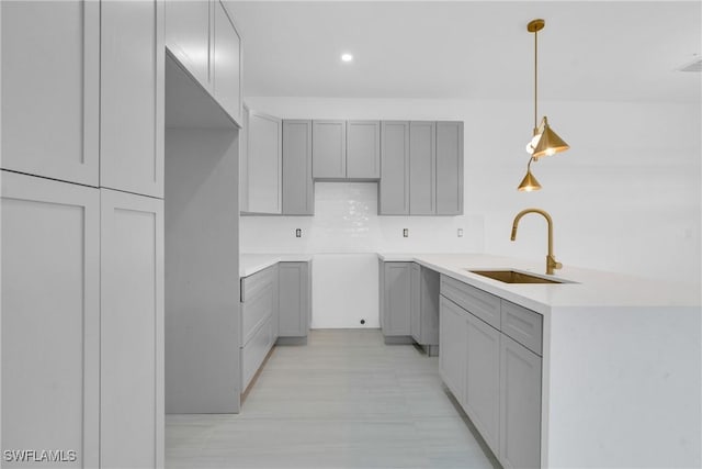 331 Naples Ave S, Lehigh Acres, FL 33974 - kitchen featuring gray cabinets, a sink, a peninsula, pendant lighting, and recessed lighting