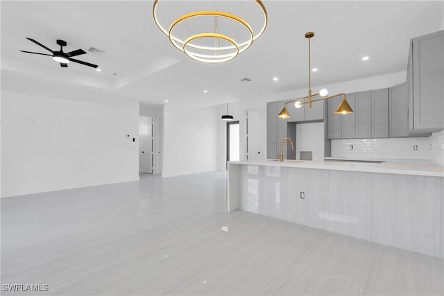 331 Naples Ave S, Lehigh Acres, FL 33974 - kitchen featuring gray cabinets, a sink, light countertops, open floor plan, and recessed lighting