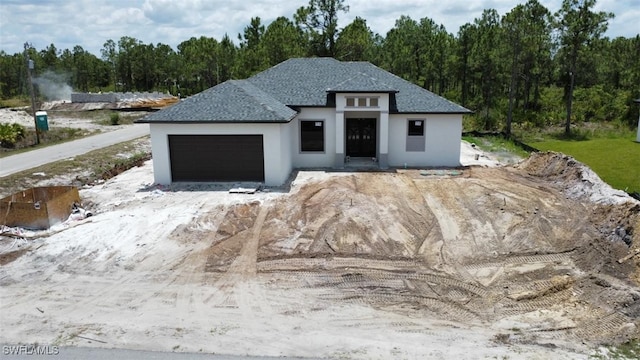 1601 W 9th St, Lehigh Acres, FL 33972 - view of front of home with stucco siding and an attached garage
