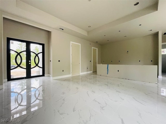 1601 W 9th St, Lehigh Acres, FL 33972 - spare room featuring a tray ceiling, french doors, baseboards, recessed lighting, and light marble finish floors