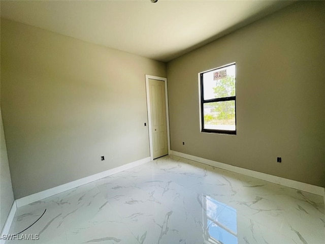 1601 W 9th St, Lehigh Acres, FL 33972 - spare room with baseboards and light marble finish floors