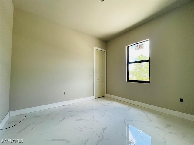 1601 W 9th St, Lehigh Acres, FL 33972 - empty room featuring light marble finish flooring and baseboards