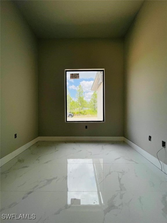 1601 W 9th St, Lehigh Acres, FL 33972 - empty room with marble finish floors and baseboards