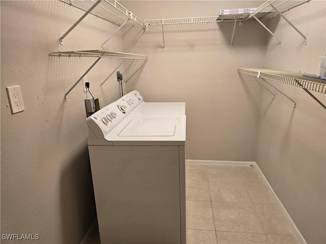 605 Squire Cir Unit 203, Naples, FL 34104 - laundry area featuring washer / clothes dryer and light tile patterned floors