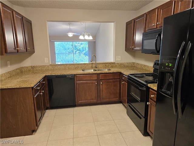 605 Squire Cir Unit 203, Naples, FL 34104 - kitchen featuring black appliances, light tile patterned floors, light stone countertops, a chandelier, and a textured ceiling