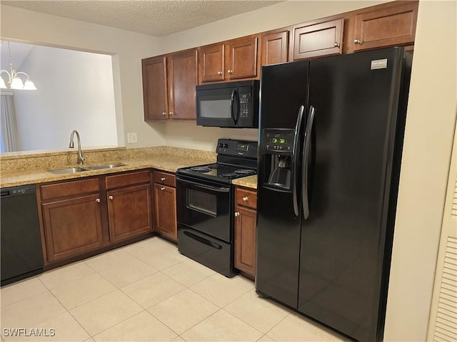 605 Squire Cir Unit 203, Naples, FL 34104 - kitchen featuring black appliances, light tile patterned flooring, light stone countertops, a chandelier, and a textured ceiling