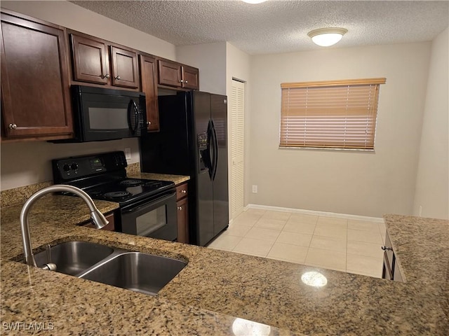 605 Squire Cir Unit 203, Naples, FL 34104 - kitchen with black appliances, light tile patterned floors, a textured ceiling, light stone counters, and dark brown cabinets