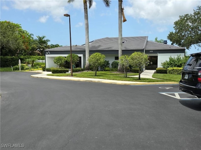 605 Squire Cir Unit 203, Naples, FL 34104 - view of front of house featuring uncovered parking