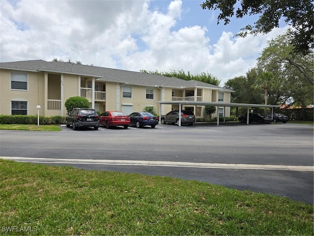 605 Squire Cir Unit 203, Naples, FL 34104 - view of building exterior featuring covered and uncovered parking