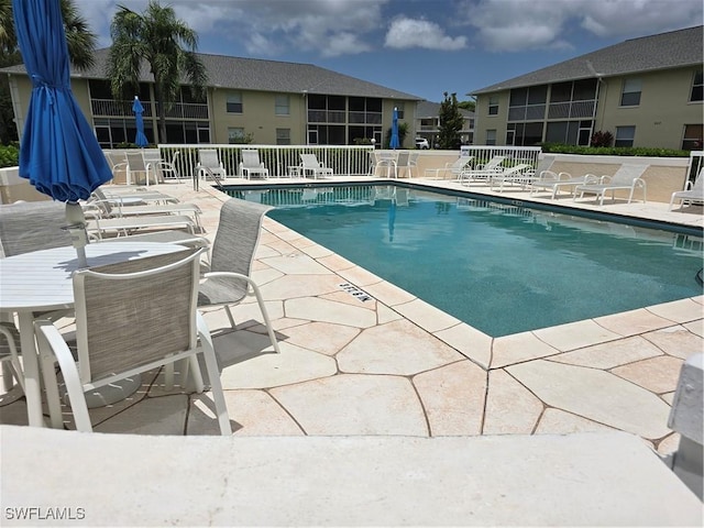 605 Squire Cir Unit 203, Naples, FL 34104 - community pool with a patio area