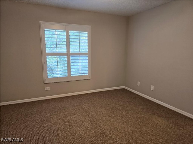 605 Squire Cir Unit 203, Naples, FL 34104 - spare room with plenty of natural light and dark colored carpet
