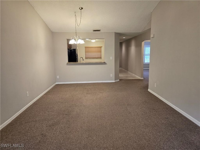 605 Squire Cir Unit 203, Naples, FL 34104 - carpeted spare room with a chandelier and a textured ceiling