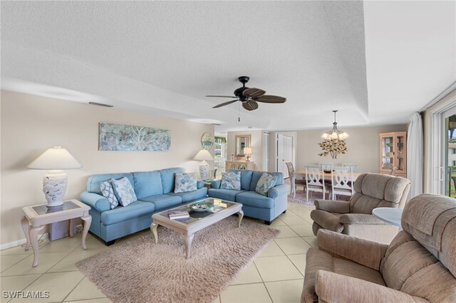 601 Teryl Rd Unit 2262, Naples, FL 34112 - living room featuring light tile patterned flooring, ceiling fan, a textured ceiling, and a chandelier
