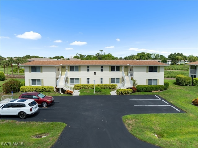 601 Teryl Rd Unit 2262, Naples, FL 34112 - view of property with stairway and uncovered parking