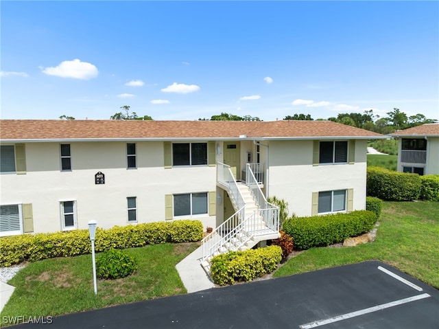 601 Teryl Rd Unit 2262, Naples, FL 34112 - view of building exterior featuring stairs and uncovered parking