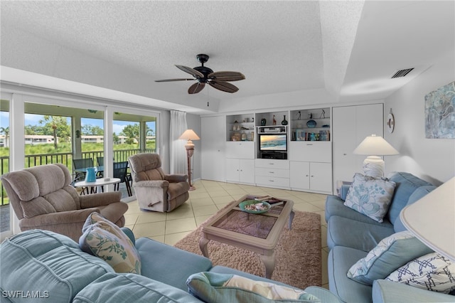 601 Teryl Rd Unit 2262, Naples, FL 34112 - living area with a textured ceiling, light tile patterned flooring, a ceiling fan, and a raised ceiling
