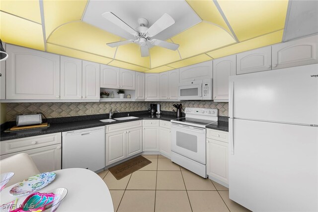601 Teryl Rd Unit 2262, Naples, FL 34112 - kitchen with white appliances, a sink, dark countertops, and light tile patterned floors