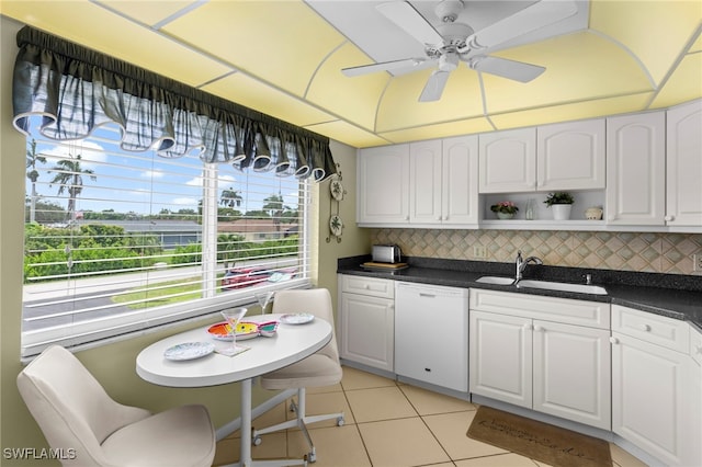 601 Teryl Rd Unit 2262, Naples, FL 34112 - kitchen featuring dishwasher, a sink, dark countertops, light tile patterned floors, and decorative backsplash