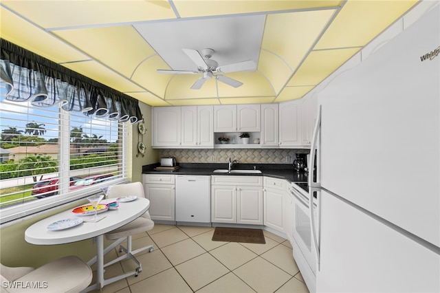 601 Teryl Rd Unit 2262, Naples, FL 34112 - kitchen with white appliances, a sink, ceiling fan, dark countertops, and light tile patterned floors