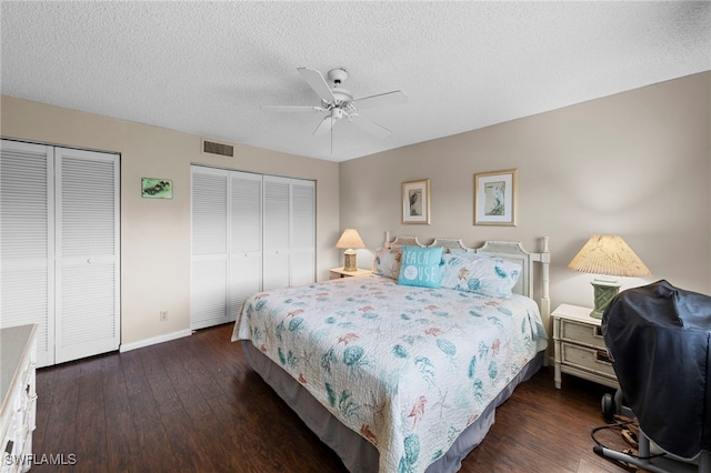 601 Teryl Rd Unit 2262, Naples, FL 34112 - bedroom featuring two closets, wood finished floors, a textured ceiling, baseboards, and a ceiling fan