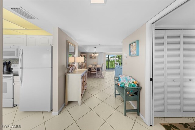 601 Teryl Rd Unit 2262, Naples, FL 34112 - corridor with a chandelier, light tile patterned floors, and baseboards