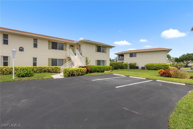 601 Teryl Rd Unit 2262, Naples, FL 34112 - view of property featuring uncovered parking and stairs