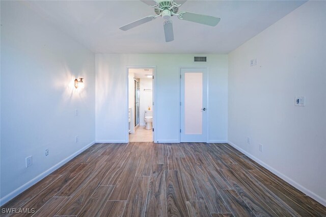 3055 Riviera Dr Unit 306, Naples, FL 34103 - spare room featuring dark wood-style flooring, baseboards, and a ceiling fan