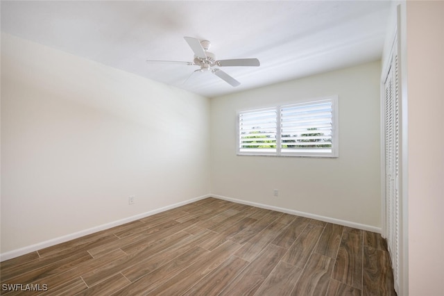 3055 Riviera Dr Unit 306, Naples, FL 34103 - spare room with wood finished floors, baseboards, and ceiling fan