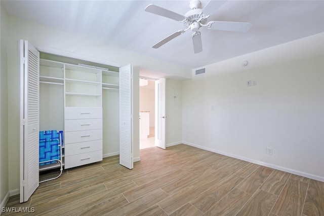 3055 Riviera Dr Unit 306, Naples, FL 34103 - unfurnished bedroom featuring wood finished floors, baseboards, and a closet