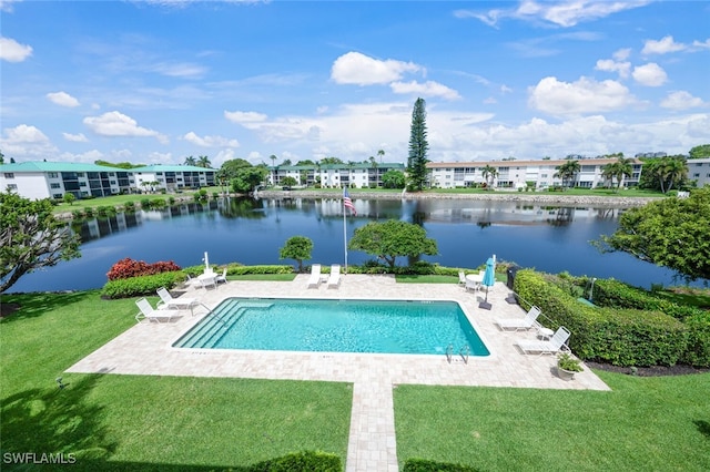 3055 Riviera Dr Unit 306, Naples, FL 34103 - view of swimming pool featuring a patio, a water view, and a lawn